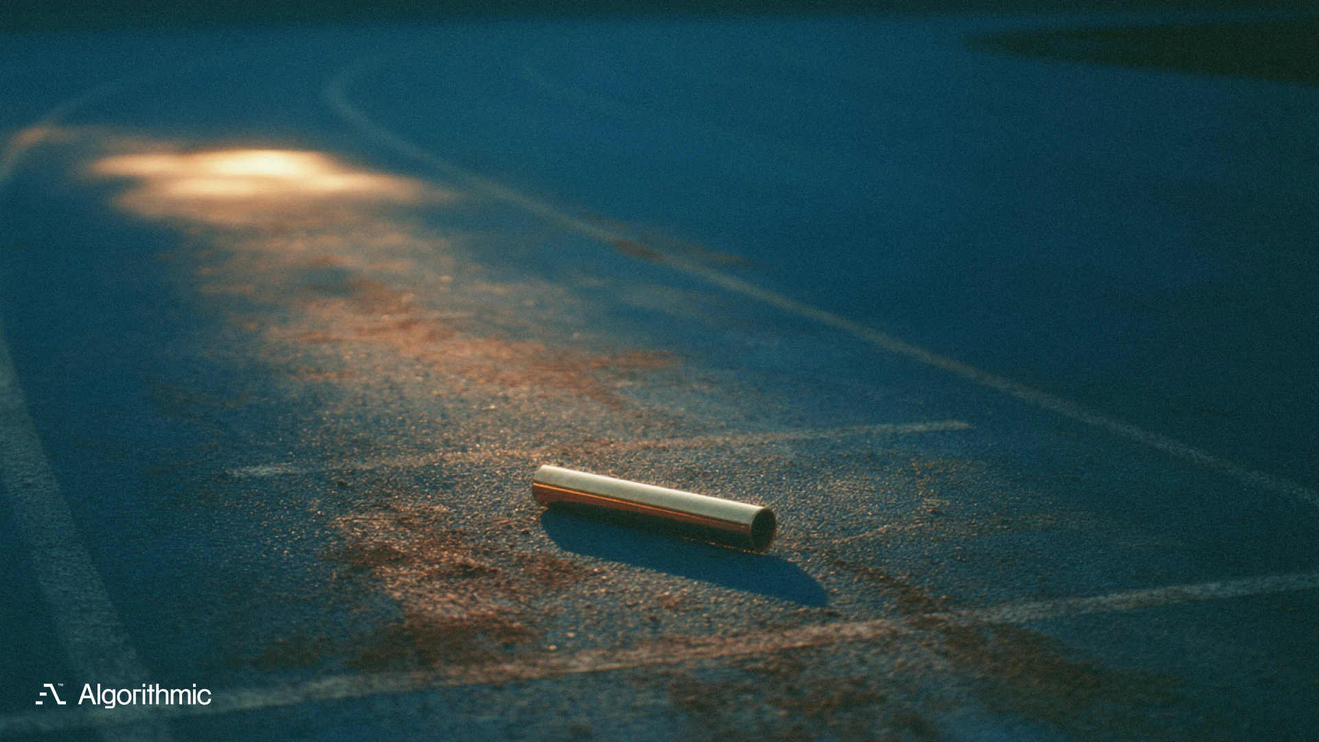 A single brass relay baton lying in the exchange zone of a running track, illustrating MLOps team structure and shared pipeline ownership.