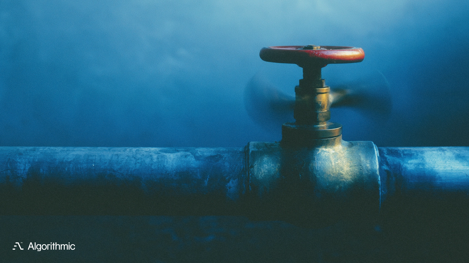 Brass gate valve on a steel pipeline, illustrating CMS and low-code deployment controls and release gating for production systems.
