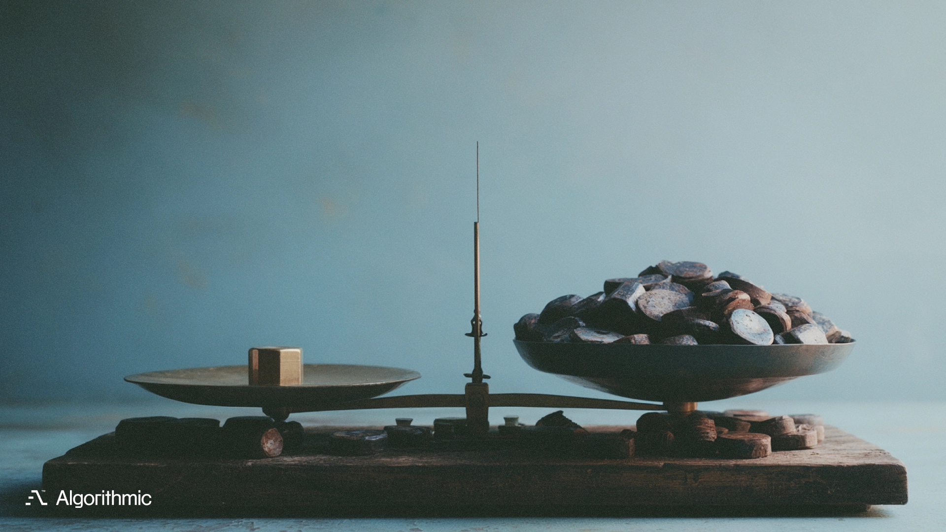 A brass balance scale weighing one gold weight against many coins, illustrating how to scope software around business decisions.
